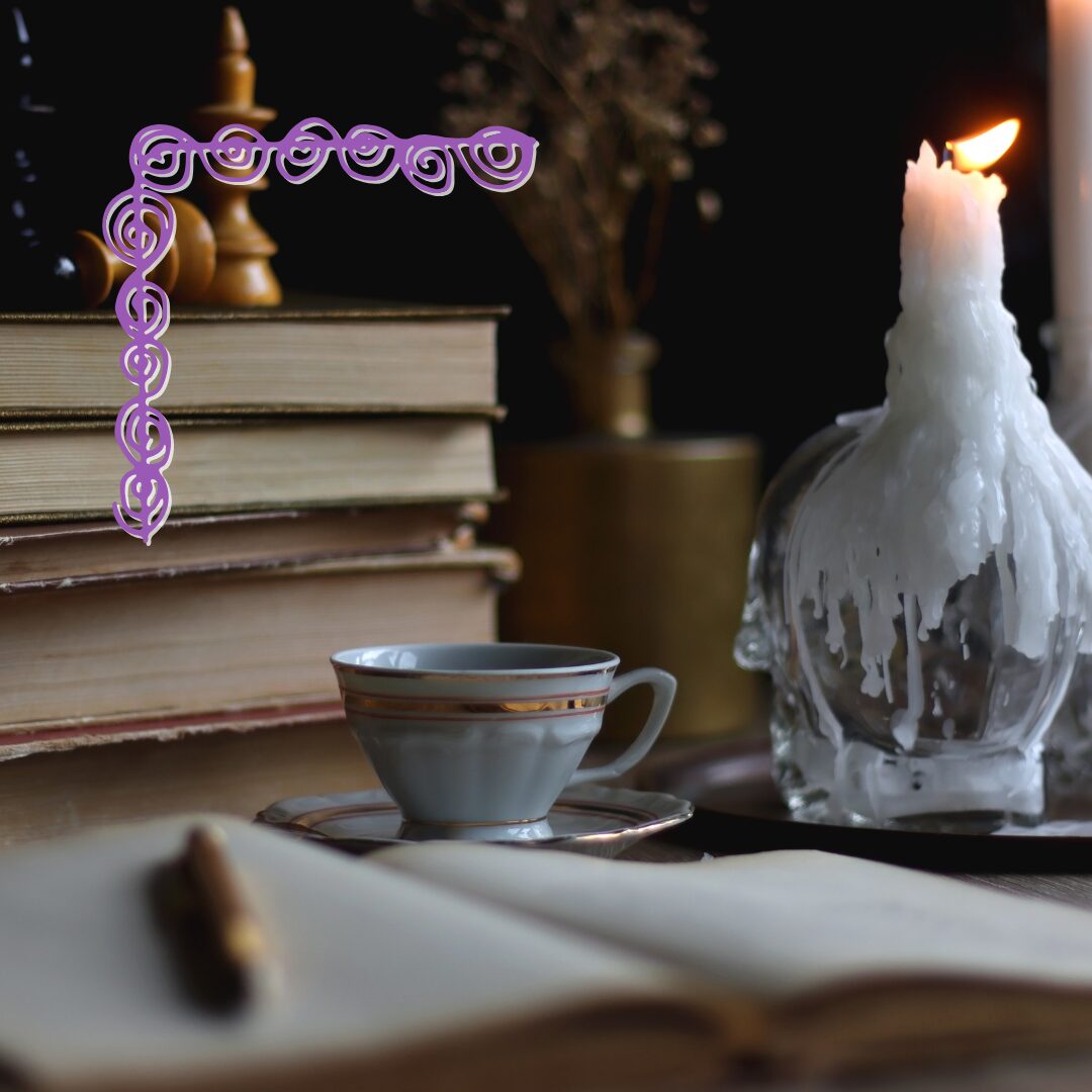 a journal, open to a blank page with a pen atop it sits on a surface with a porcelain cup and saucer beyond it, next to a bottle covered in dripped candle wax holding a lit candle, the flame blown to the side