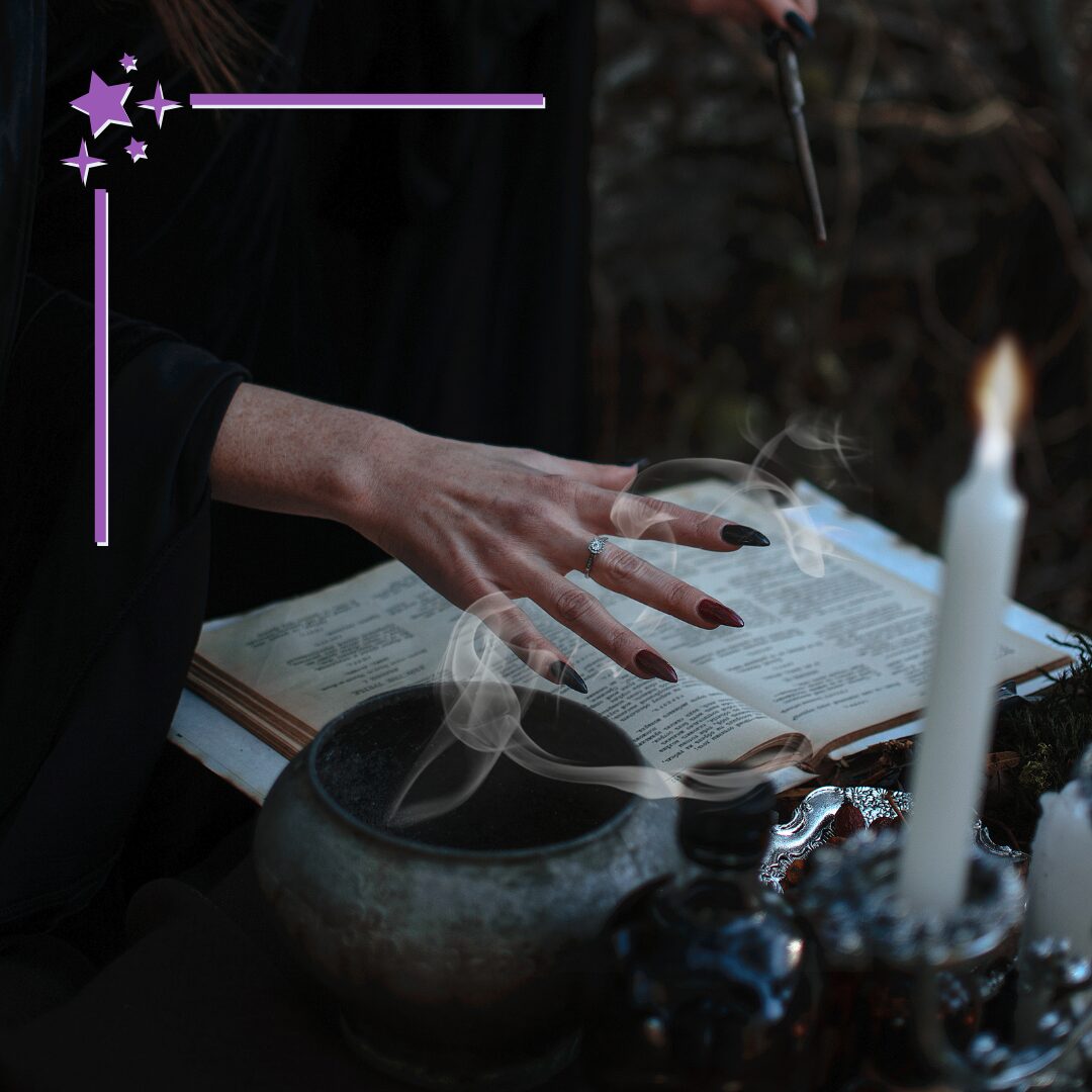 a spread hand with long black nails over an open book, a trail of smoke and a lit candle in the foreground, a wand in the background