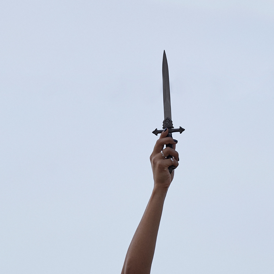 a hand holding an athame