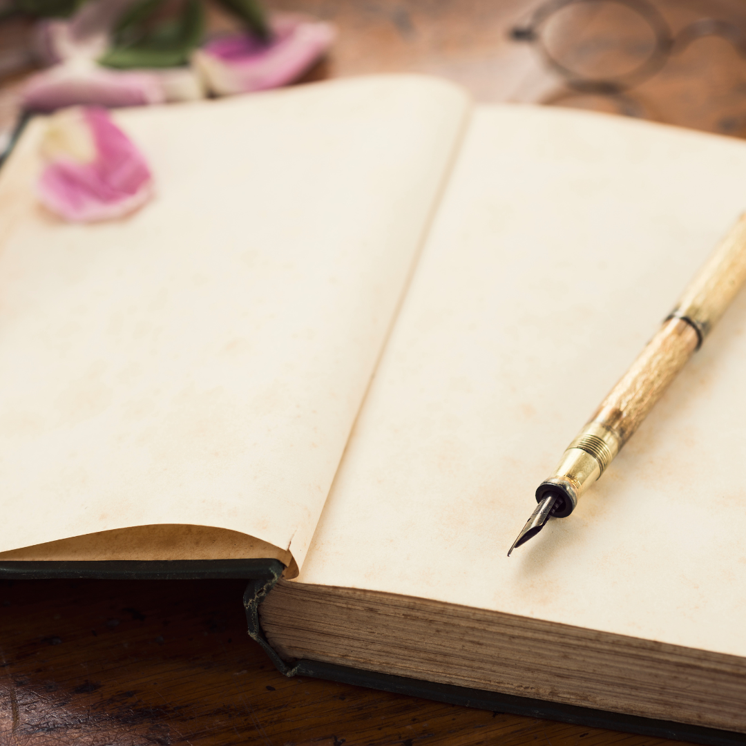 A journal, open to the blank first page, with a fountain pen.